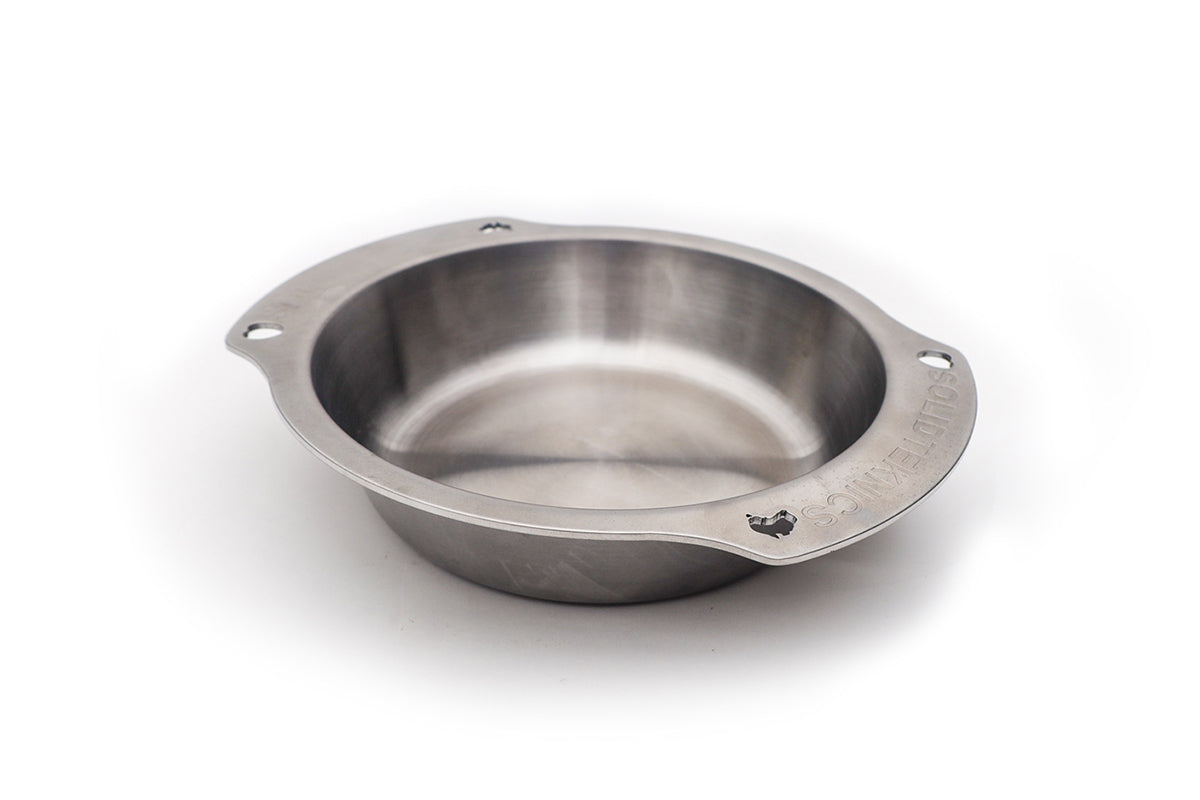 Silver Solidteknics Noni oven-to-table pan with a round cooking surface and two flat side handles