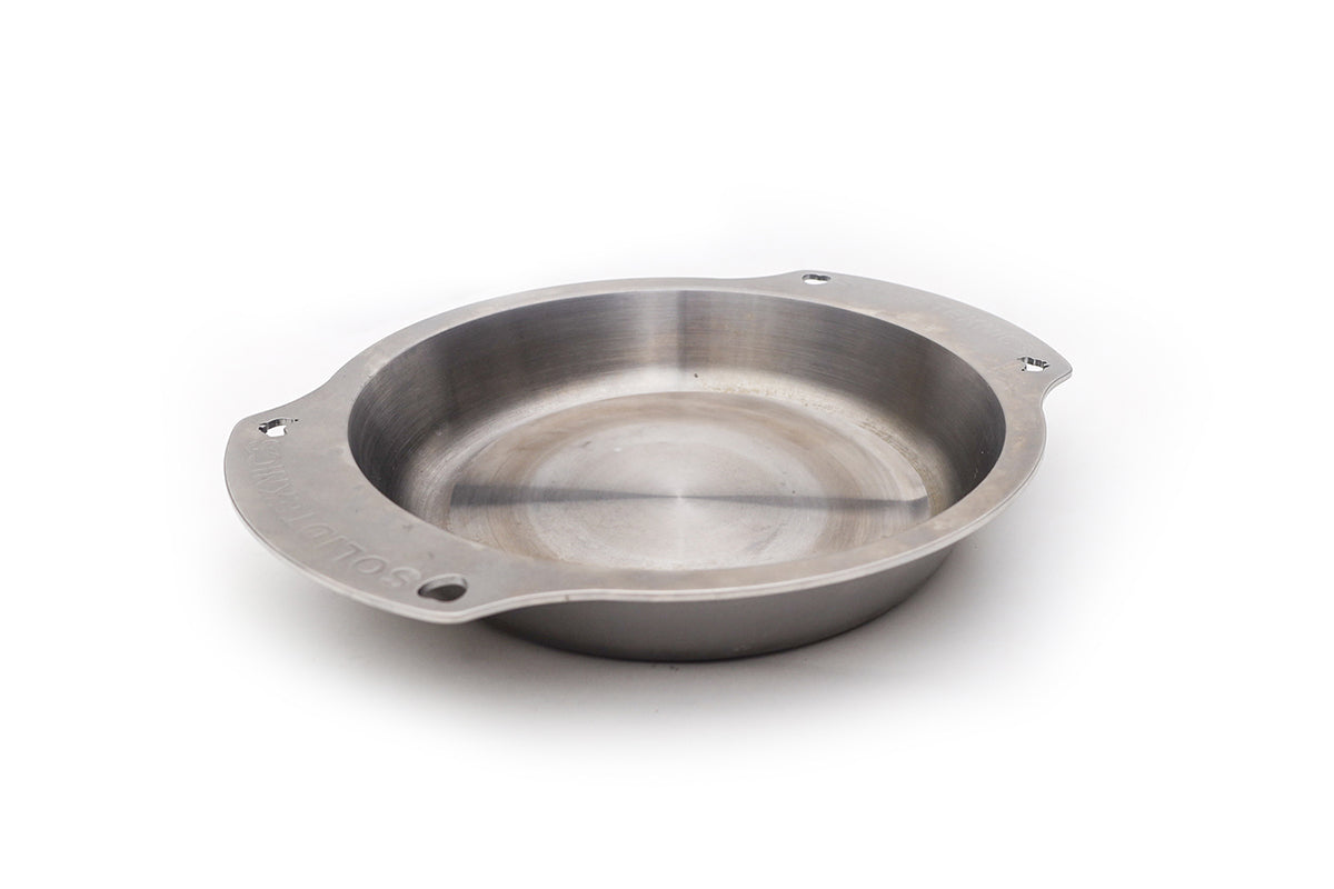 Silver Solidteknics Noni oven-to-table pan with a round cooking surface and two flat side handles