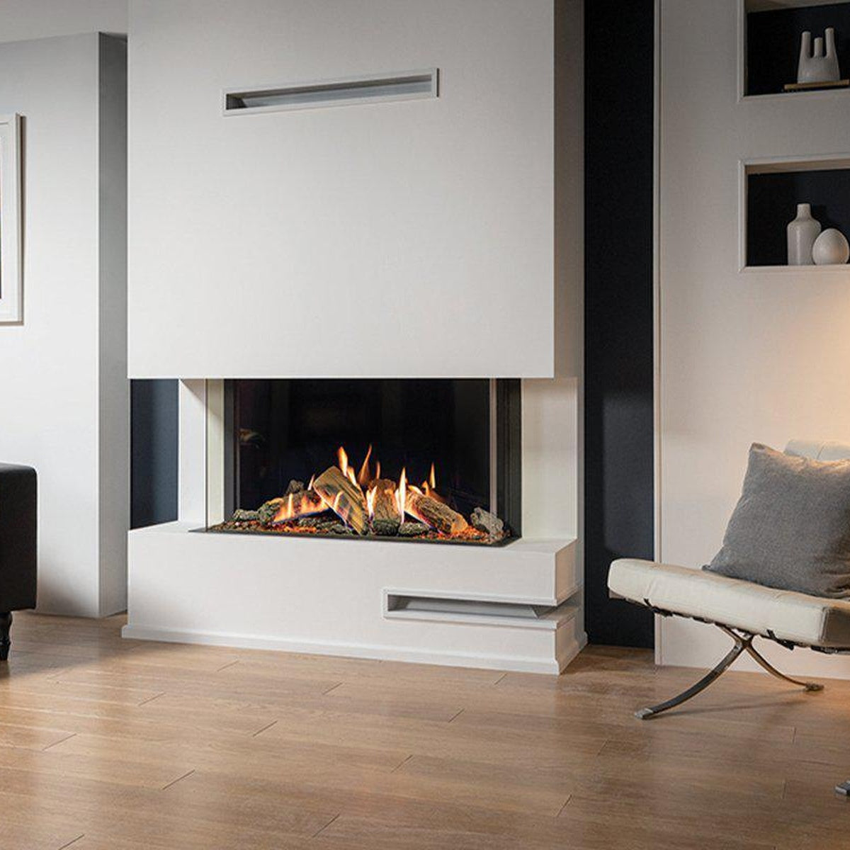 Gazco Reflex 105 Multi-sided gas fire beside a blue armchair