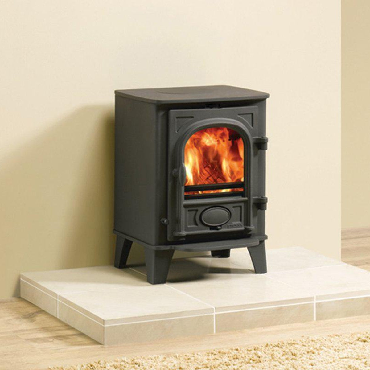 Stovax Stockton 3 Matt Black multi-fuel stove on a limestone hearth