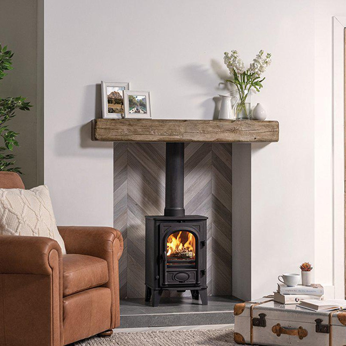 Stovax Stockton 4 Matt Black multi-fuel stove with stone mantel and chevron fireplace tiles