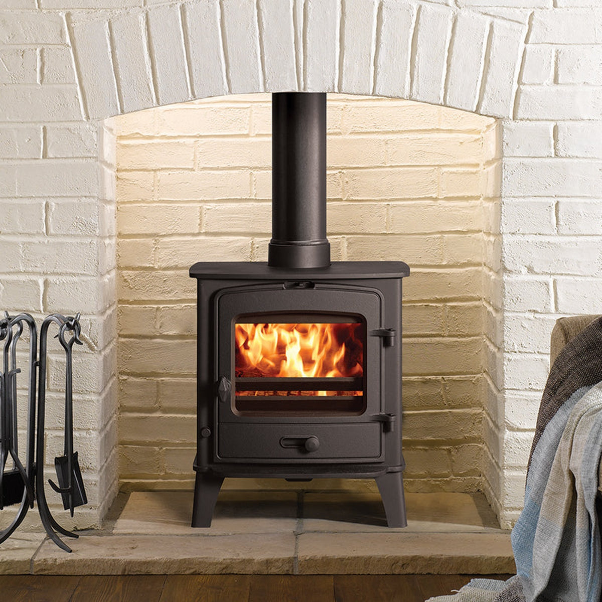 Stovax County 5 stove on a hearth in a pale brick recess
