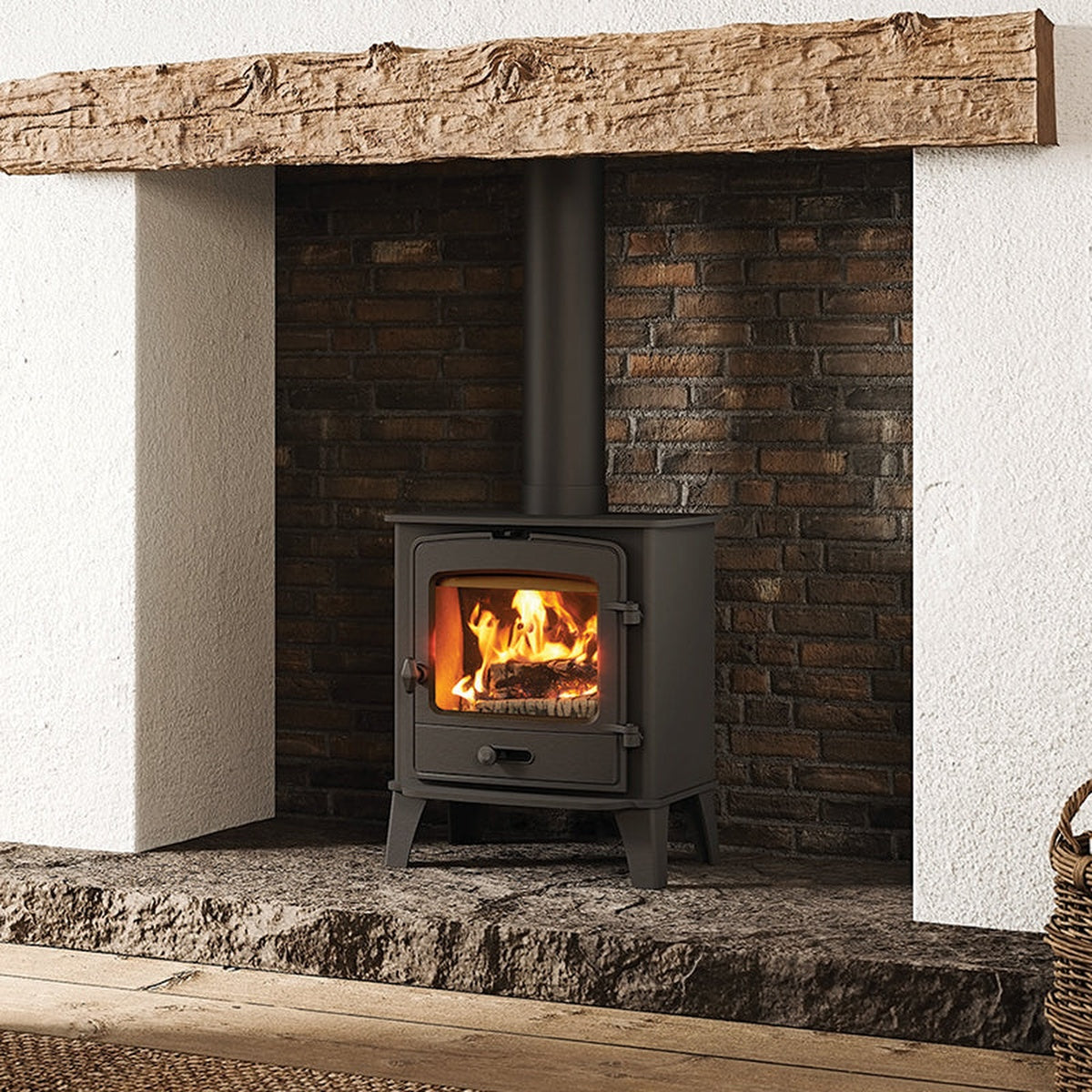 Stovax County 5 stove in a stone fireplace beneath a rustic beam