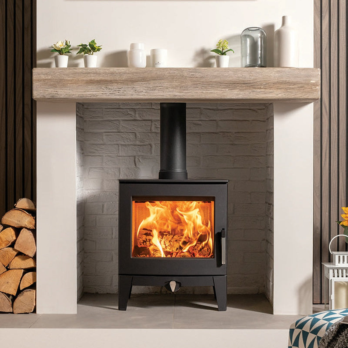 Stovax Futura 5 beneath a mantel beside a yellow chair