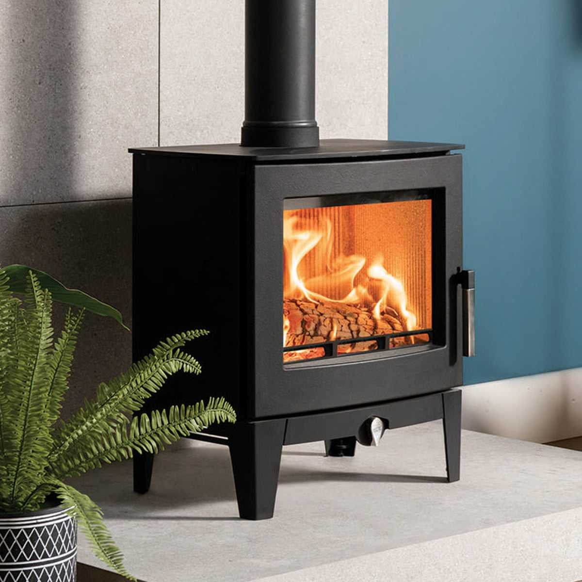 Stovax Futura 5 on a hearth beside a plant