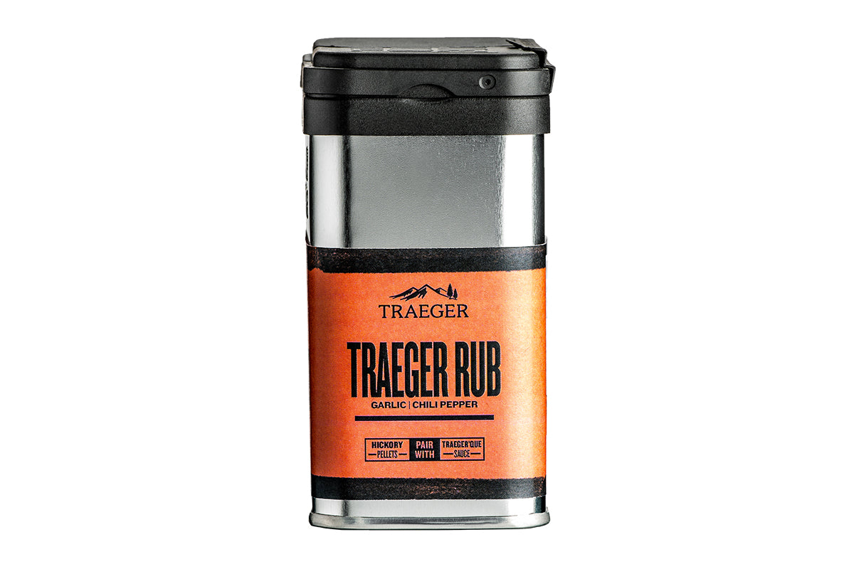 Cropped view of a Traeger Rub container. The container features a silver and black body with an orange label displaying the Traeger logo and the flavor description: garlic chili pepper. The label also provides pairing suggestions for the rub.