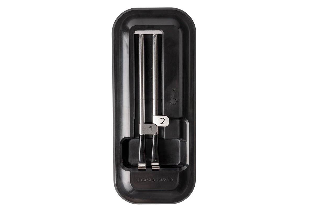 Two Traeger x MEATER wireless meat probes numbered 1 and 2 in their black holder
