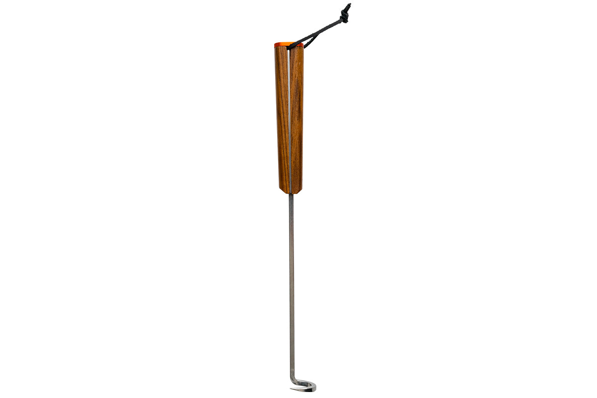 Traeger BBQ Pig Tail shown upright with a wooden handle, hanging loop and hooked metal tip