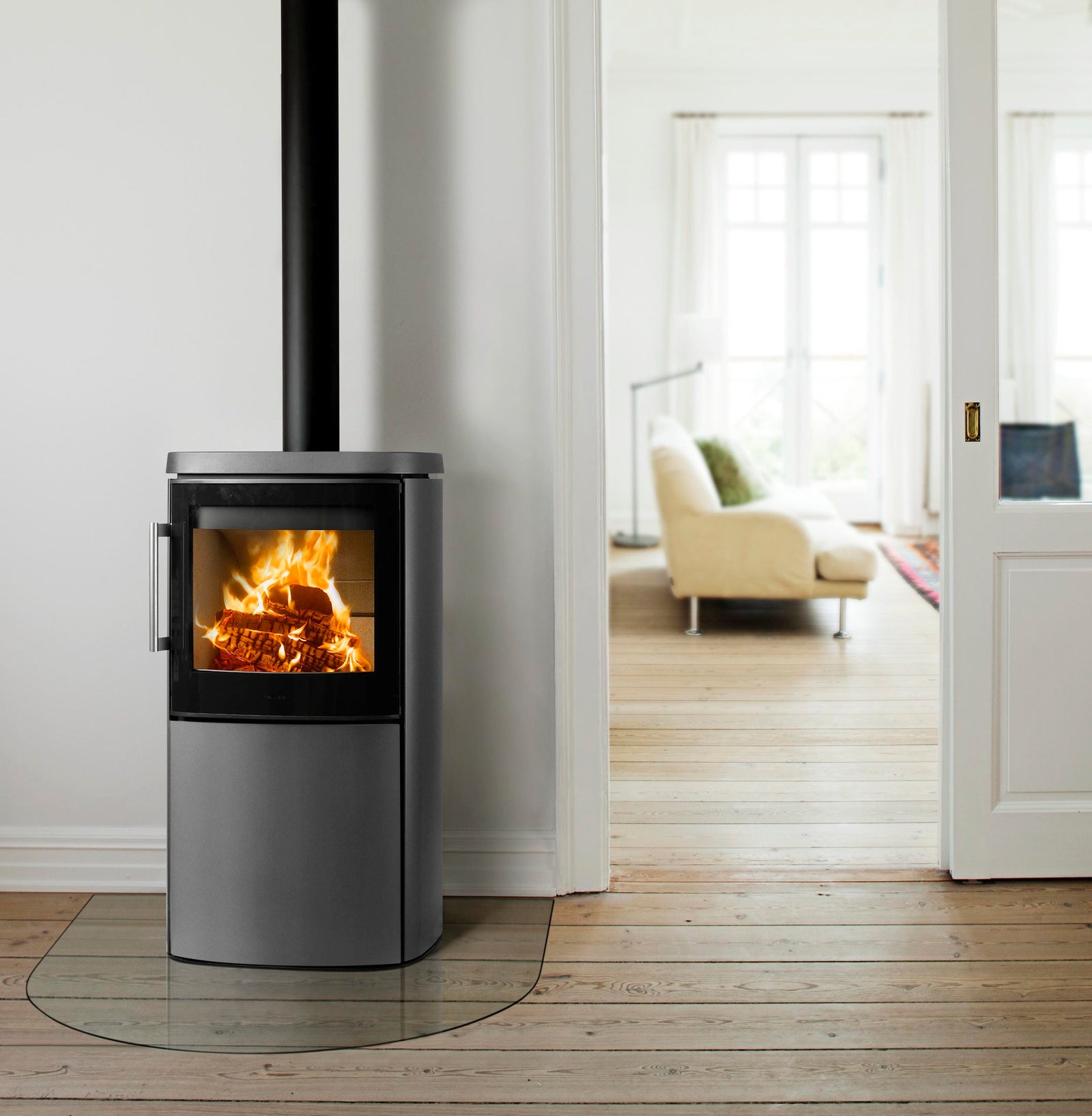 HWAM 4640 wood-burning stove in grey in a bright white room