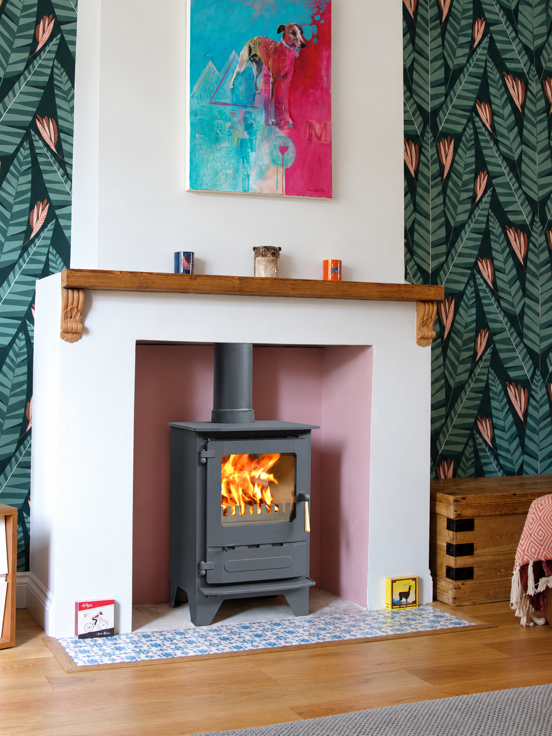 Dunsley Highlander 5 Enviroburn SG with high legs and a wood handle burning logs in a colour room setting