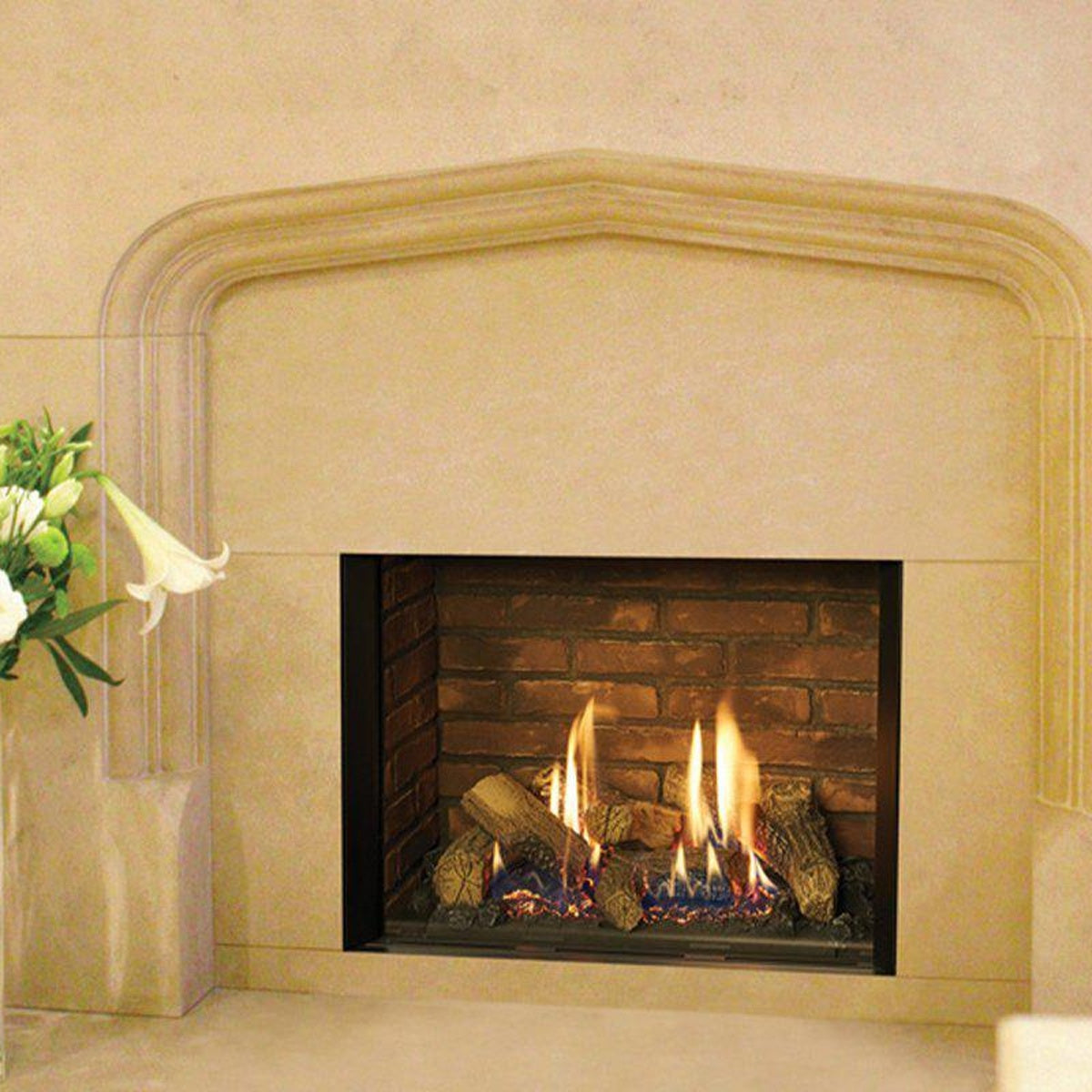 Gazco Riva2 500 Edge gas fire with brick-effect lining in a cream stone fireplace