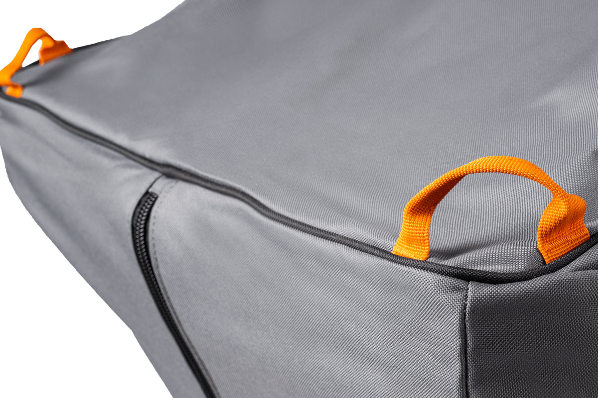 Close-up of orange lifting loops on the grey Traeger Timberline grill cover