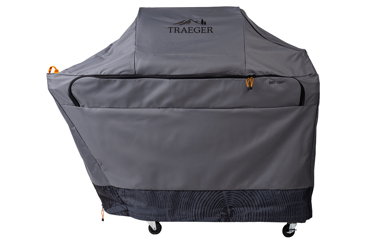 Grey Traeger Timberline full-length grill cover with a zipped front panel and patterned lower edge