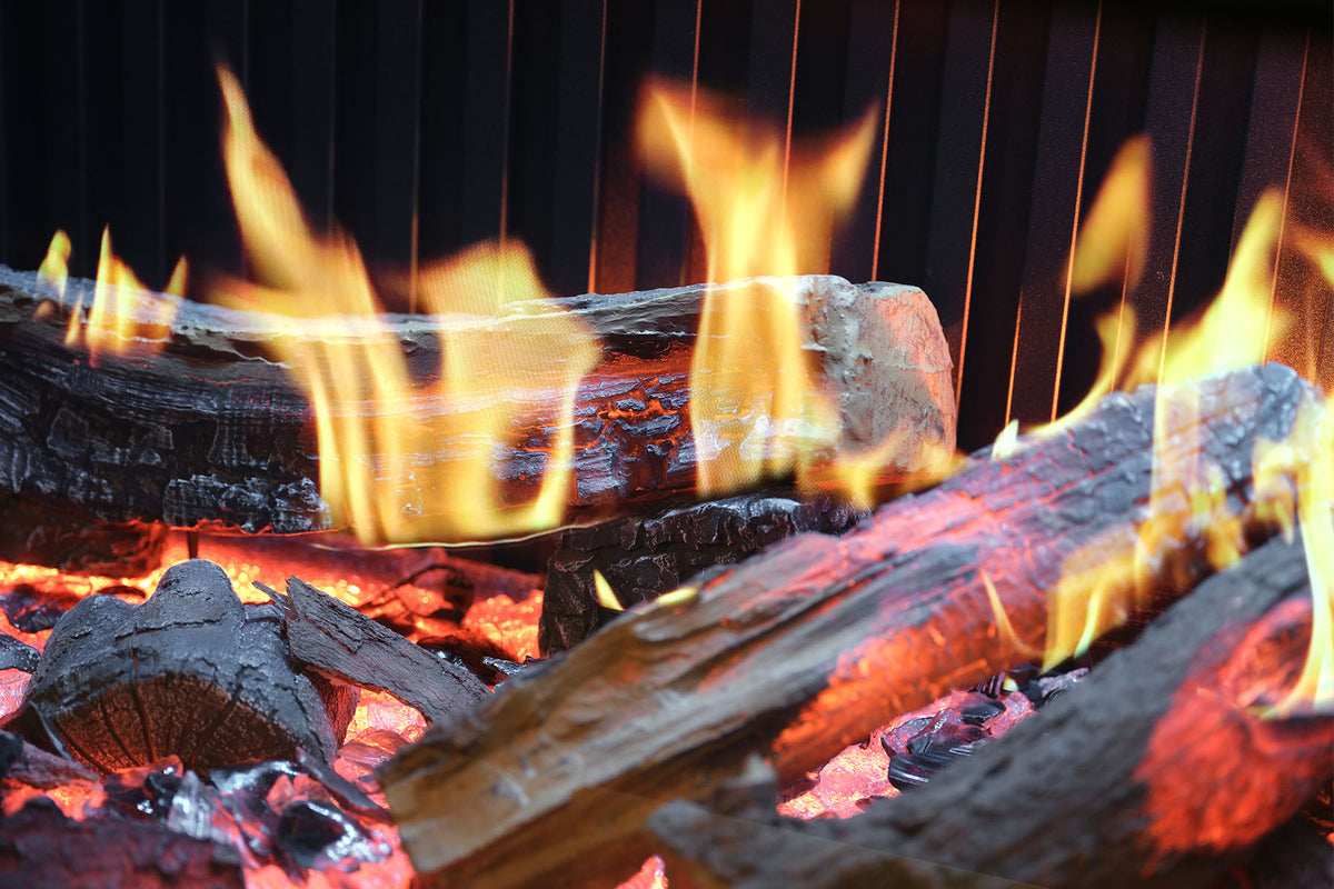 Close-up of the Solus iX15 log bed and yellow flame effect against a ribbed back panel