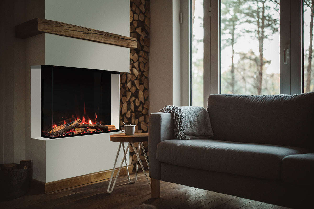 Solus VS75 electric fire with glass sides beneath a wooden mantel beside a log store