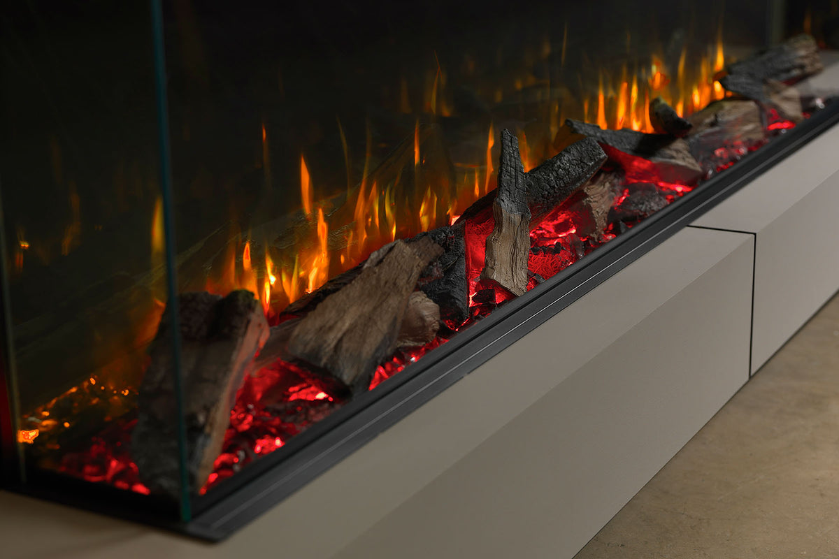 Angled close-up along the Solus VS180 log bed showing red embers and orange flame effects
