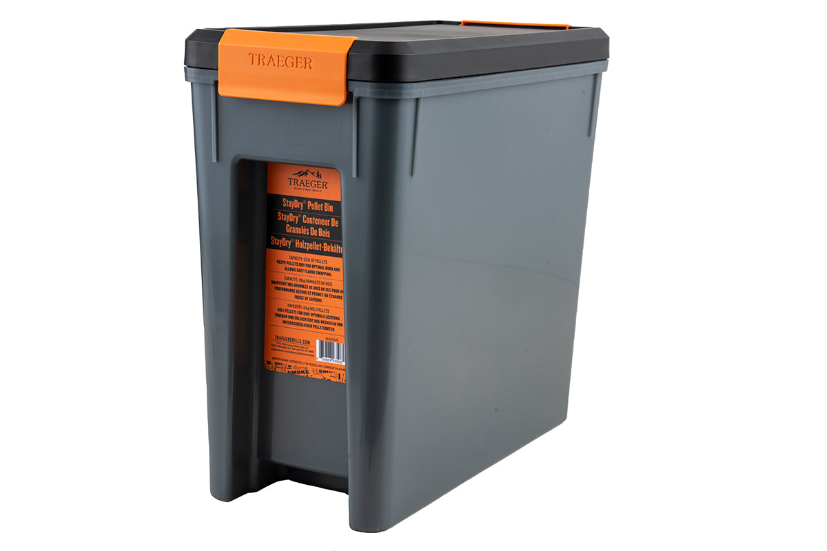 Traeger StayDRY pellet bin viewed at an angle with its orange product label visible