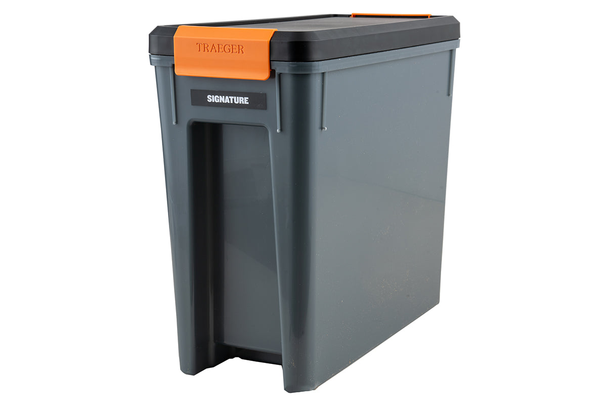 Grey Traeger StayDRY pellet bin with black lid, orange latch and Signature label