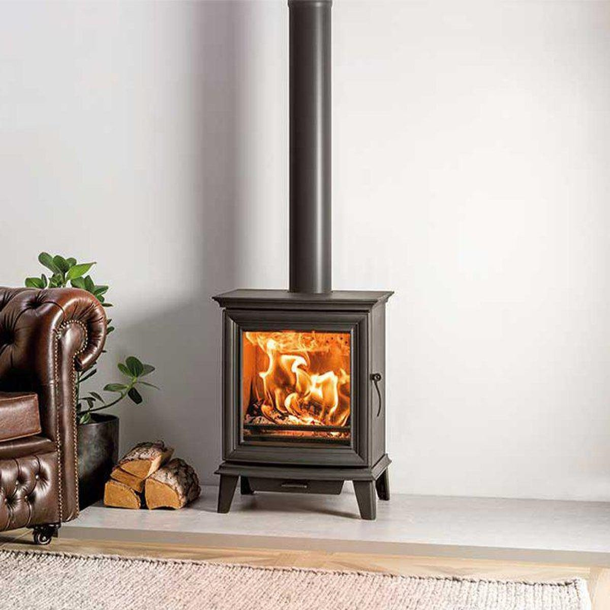 Stovax Chesterfield 5 stove beside a brown leather sofa