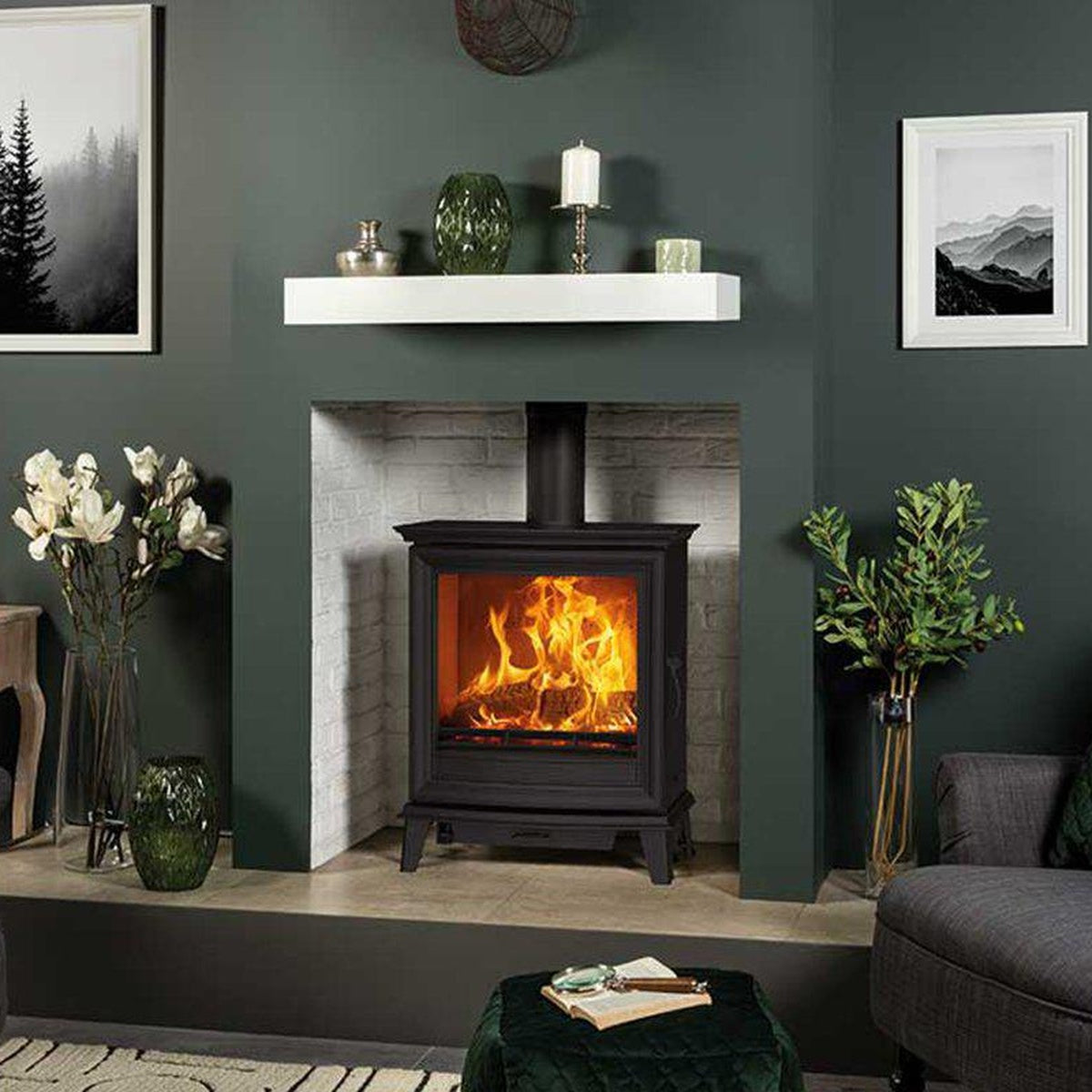 Stovax Chesterfield 5 Wide stove in a fireplace against a green wall