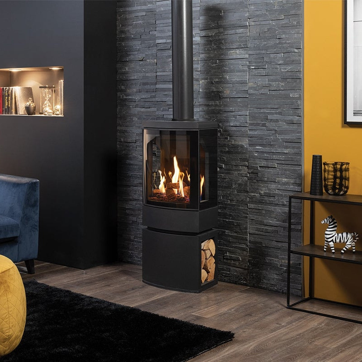Gazco Loft gas stove with a dark log-store base beside a sofa