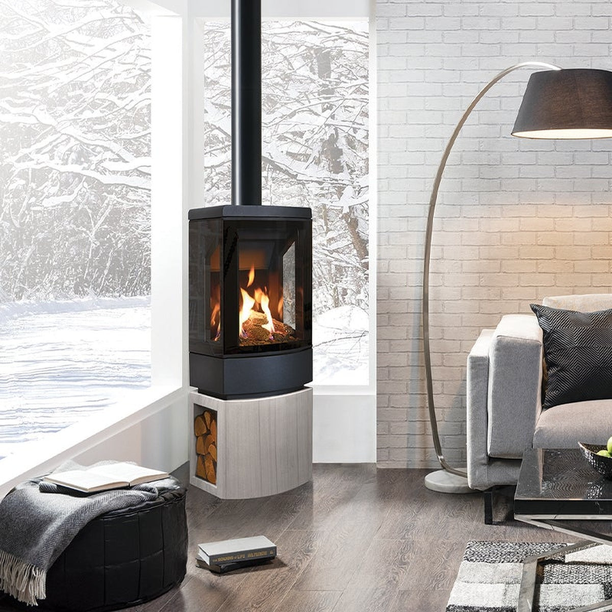 Gazco Loft gas stove with a light stone log-store base beside a window