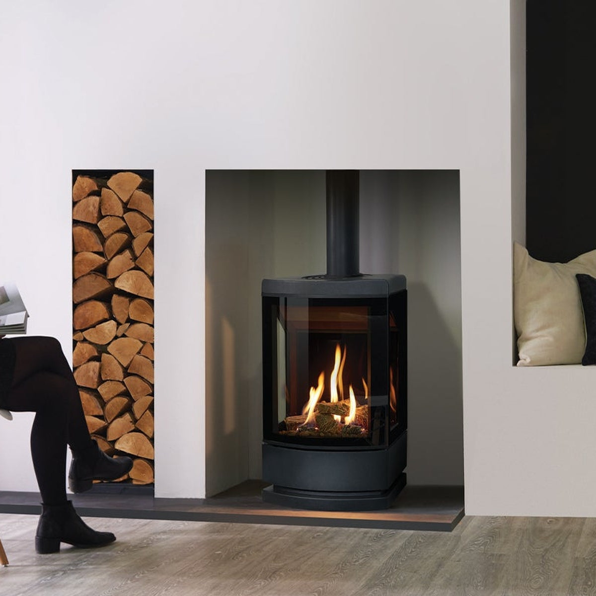 Gazco Loft gas stove with a dark plinth in a fireplace opening