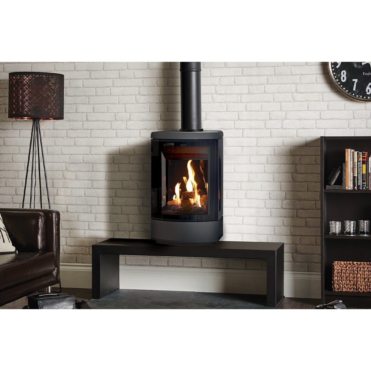 Gazco Loft gas stove on an optional bench against a white brick wall