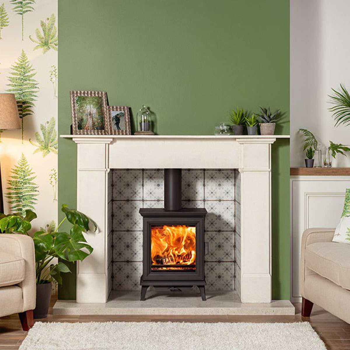 Stovax Sheraton 5 with a pale mantel against a green wall