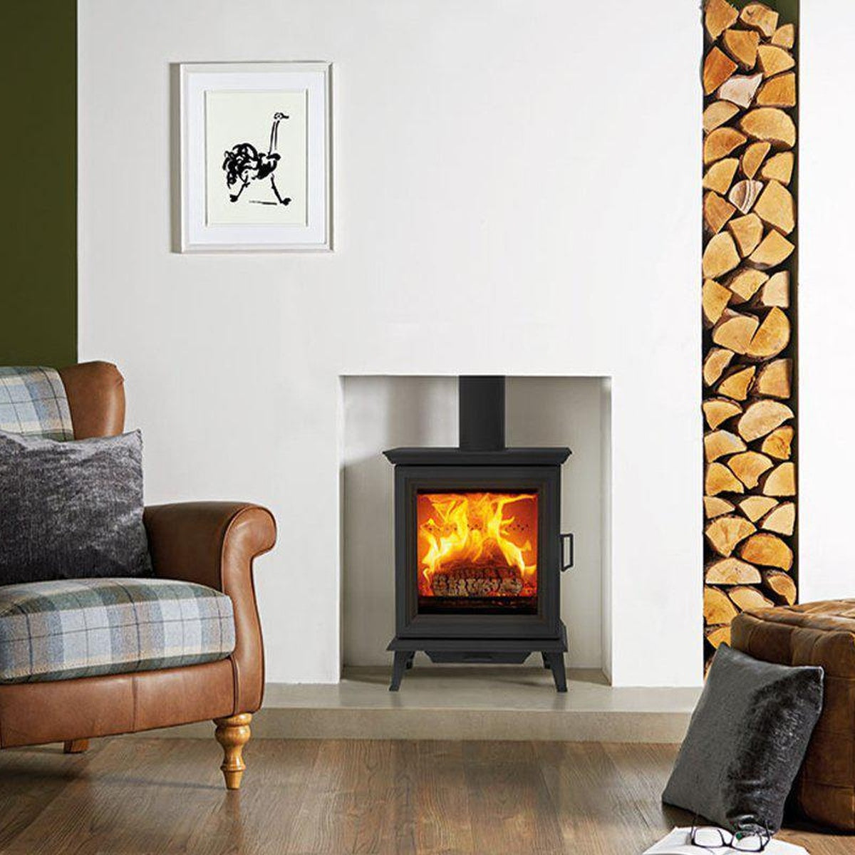 Stovax Sheraton 5 in a recessed fireplace beside an armchair