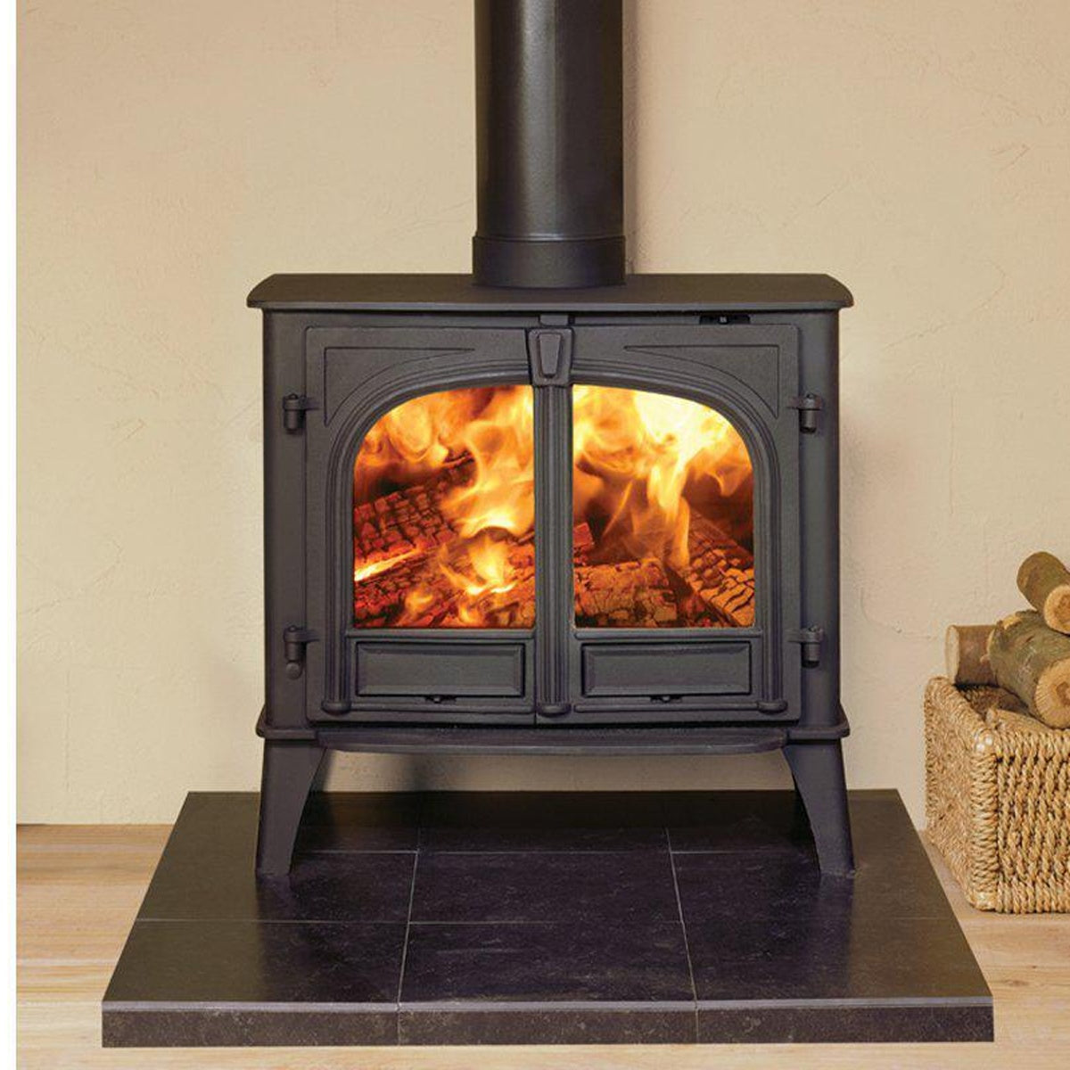Stovax Stockton 11 Matt Black double-door woodburning stove on a dark hearth