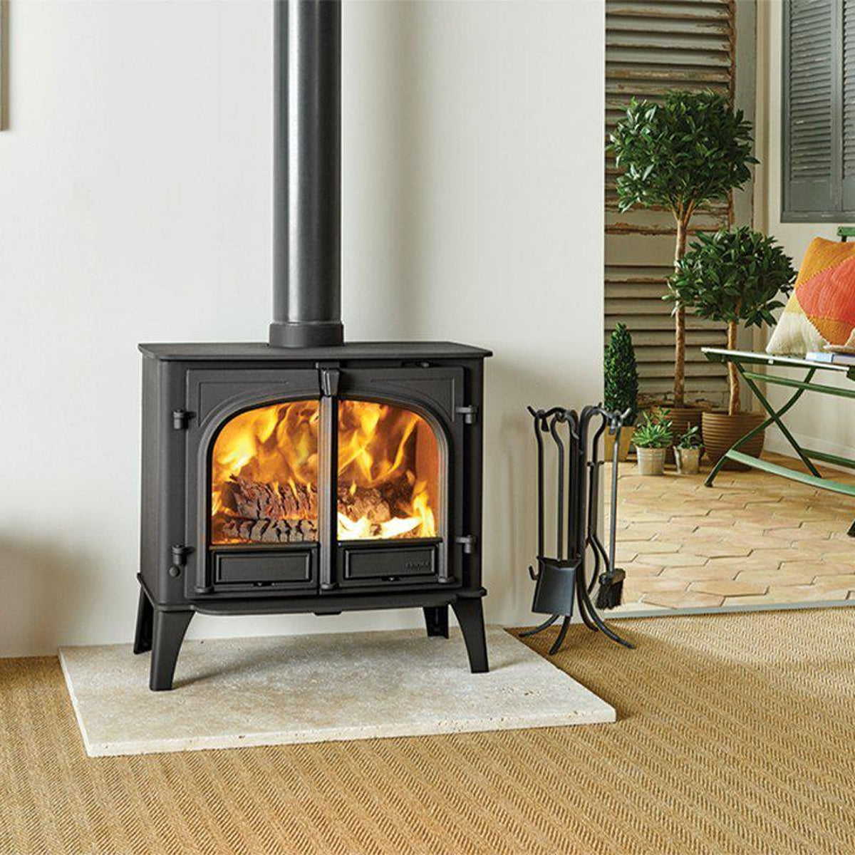 Stovax Stockton 11 Matt Black double-door woodburning stove in a room with French doors