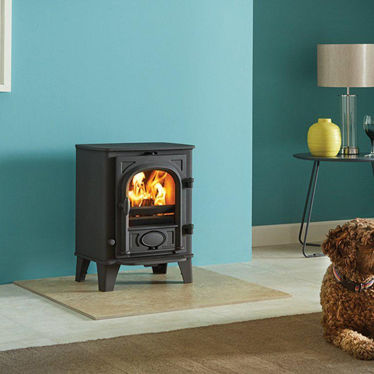 Stovax Stockton 3 Matt Black multi-fuel stove in a teal room with a dog