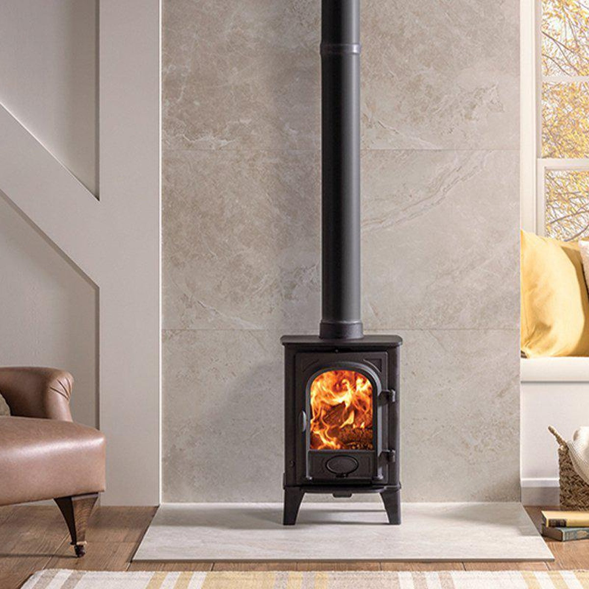 Stovax Stockton 4 Matt Black woodburning stove beside a pink chair