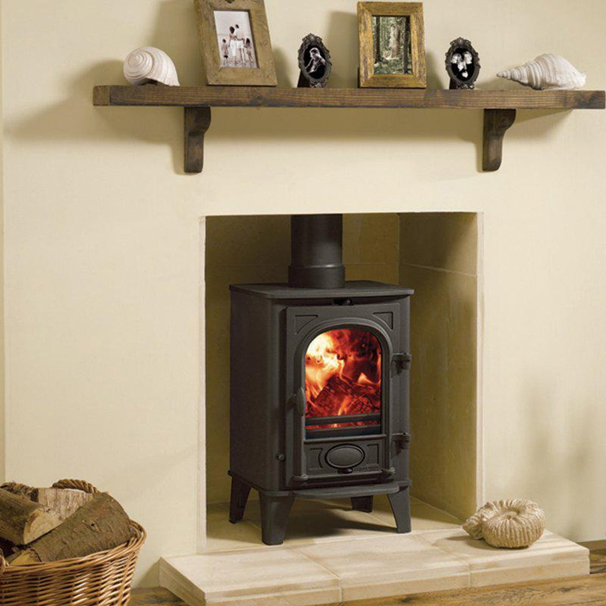 Stovax Stockton 4 Matt Black multi-fuel stove beneath a stone shelf