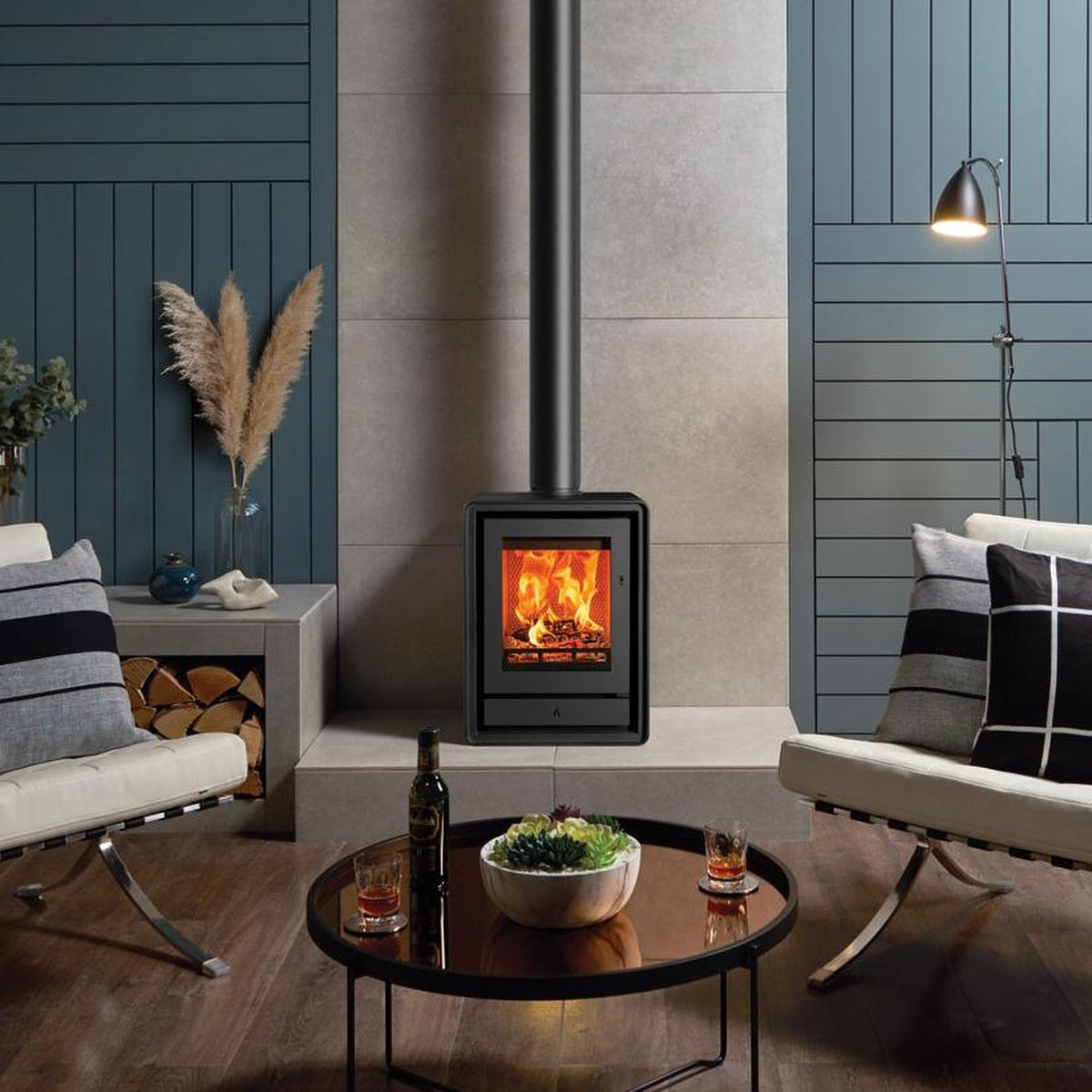 Stovax Riva2 40 freestanding fire between two pale sofas in a blue room