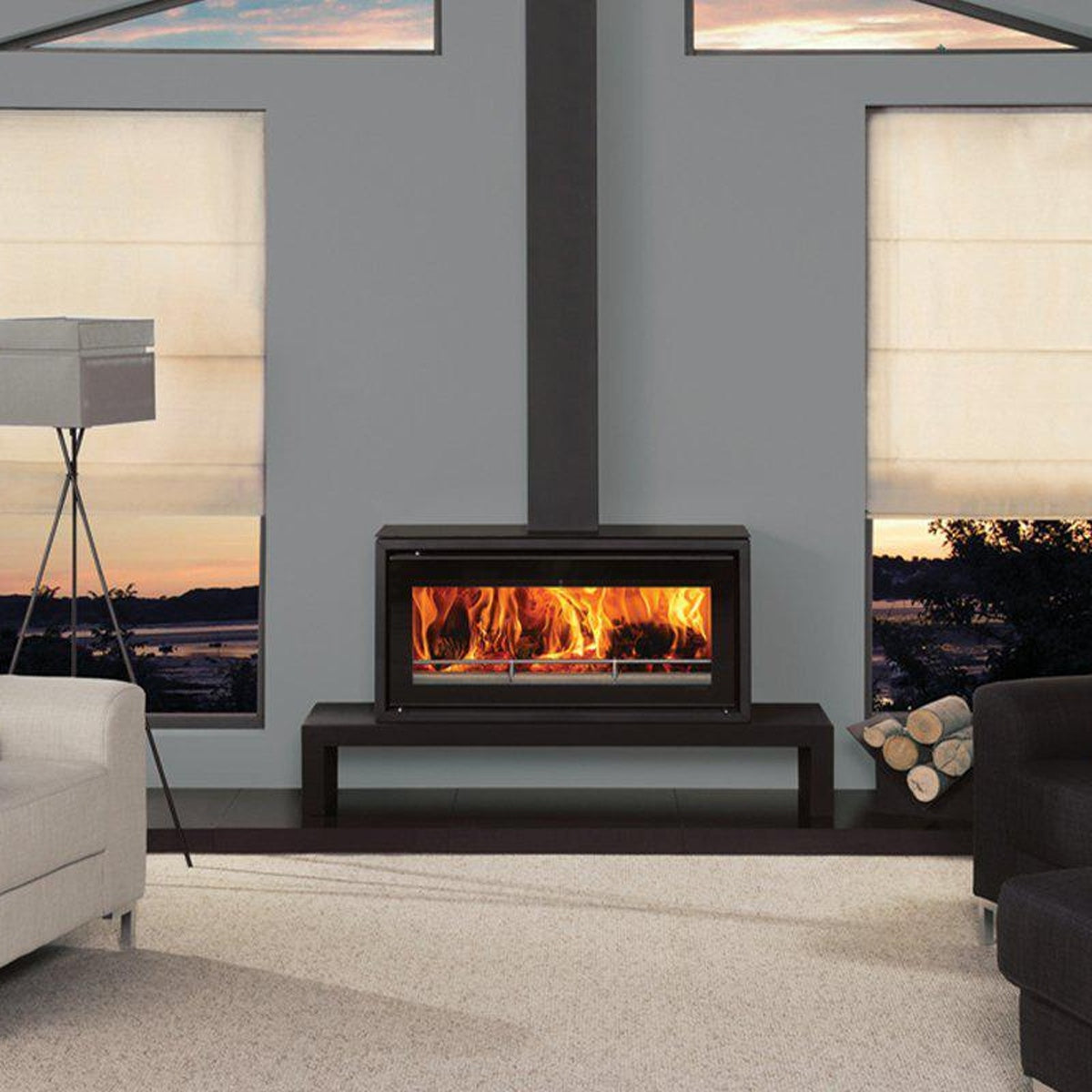 Stovax Studio 2 Freestanding wood burning stove on a low bench between sofas — The Stove Yard