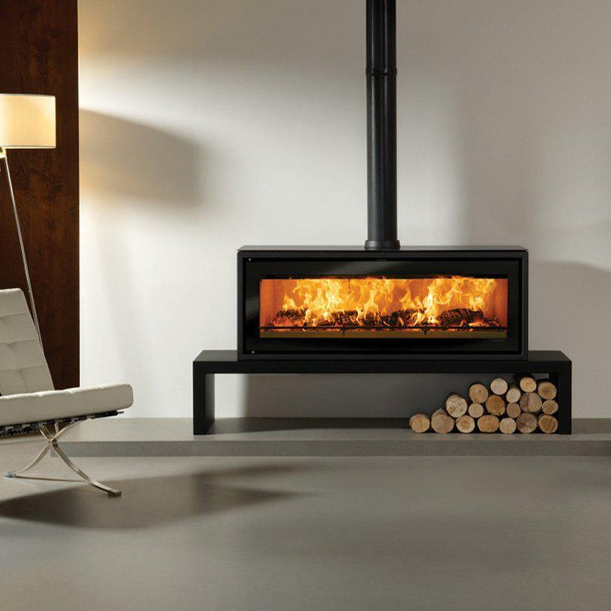 Stovax Studio 3 Freestanding wood burning stove on Riva 180 High Bench shown with decorative black flue ring cover — The Stove Yard