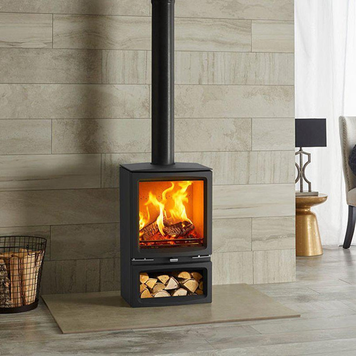 Stovax Vogue Medium stove with Midline log-store base beside a pale brick wall