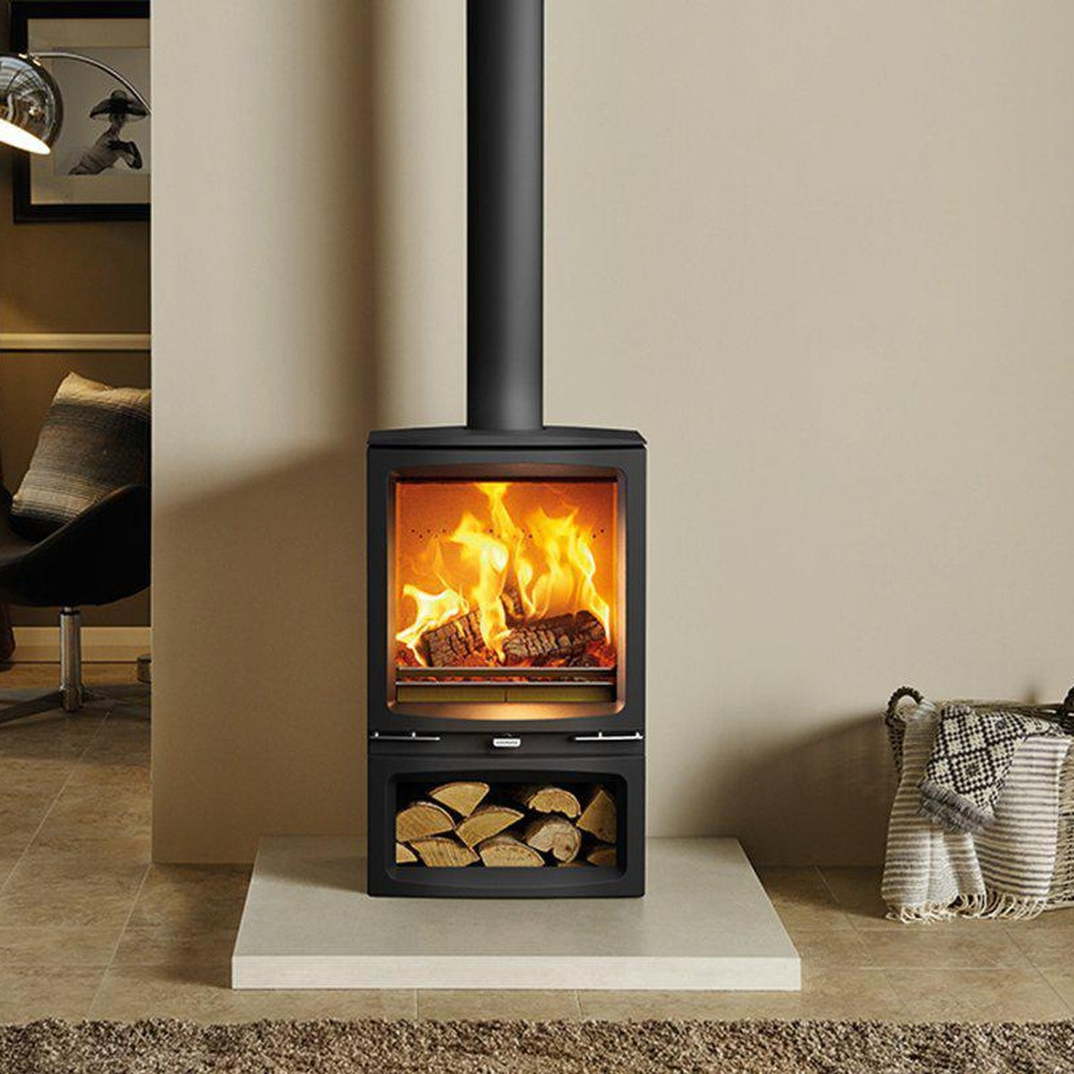Stovax Vogue Medium stove with Midline log-store base beside a woven basket