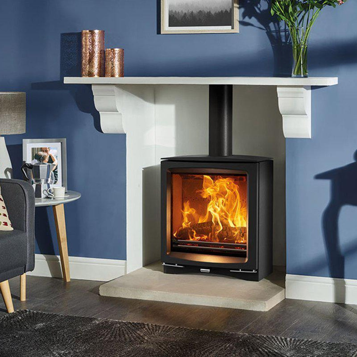 Stovax Vogue Medium Slimline multi-fuel stove with plinth beneath a pale mantel