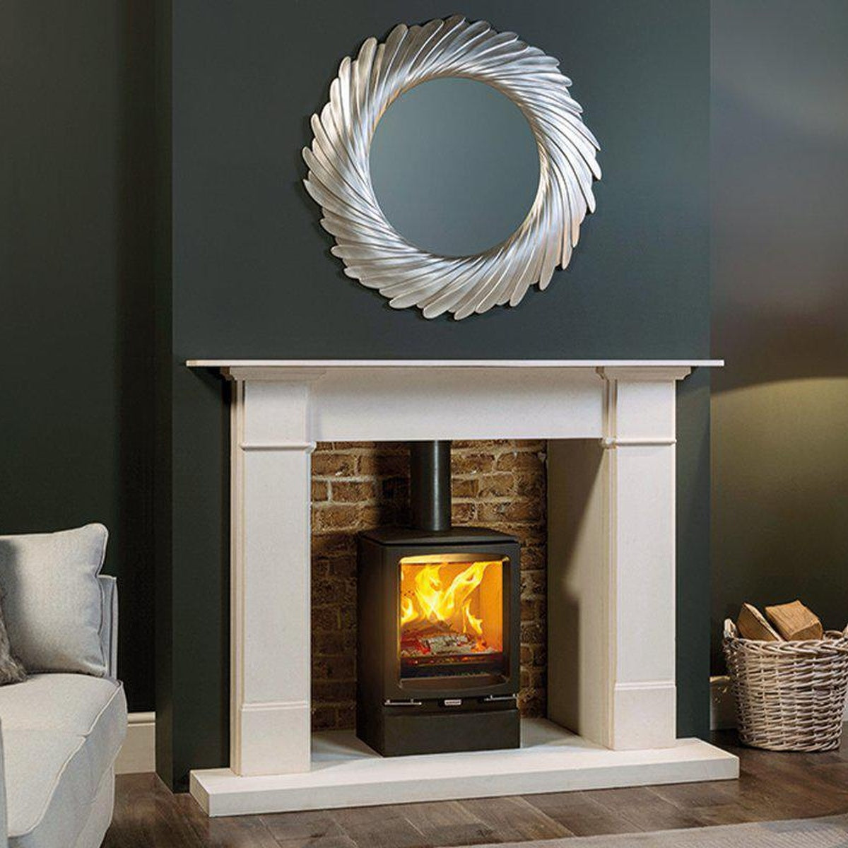Stovax Vogue Midi stove with plinth beneath a pale stone mantel