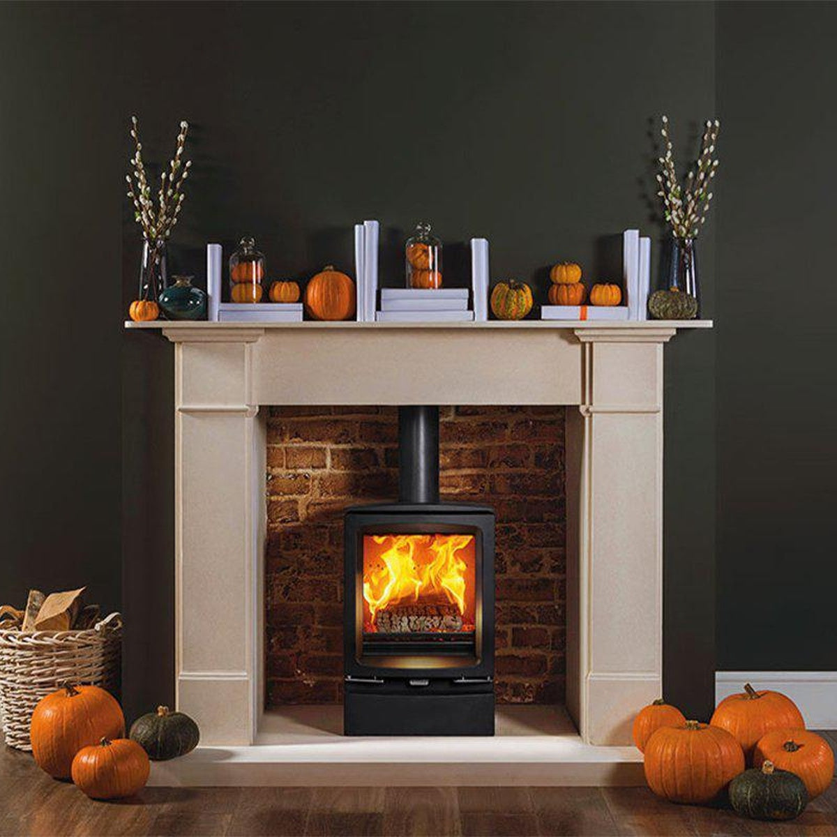 Stovax Vogue Midi stove with plinth in an autumn fireplace setting