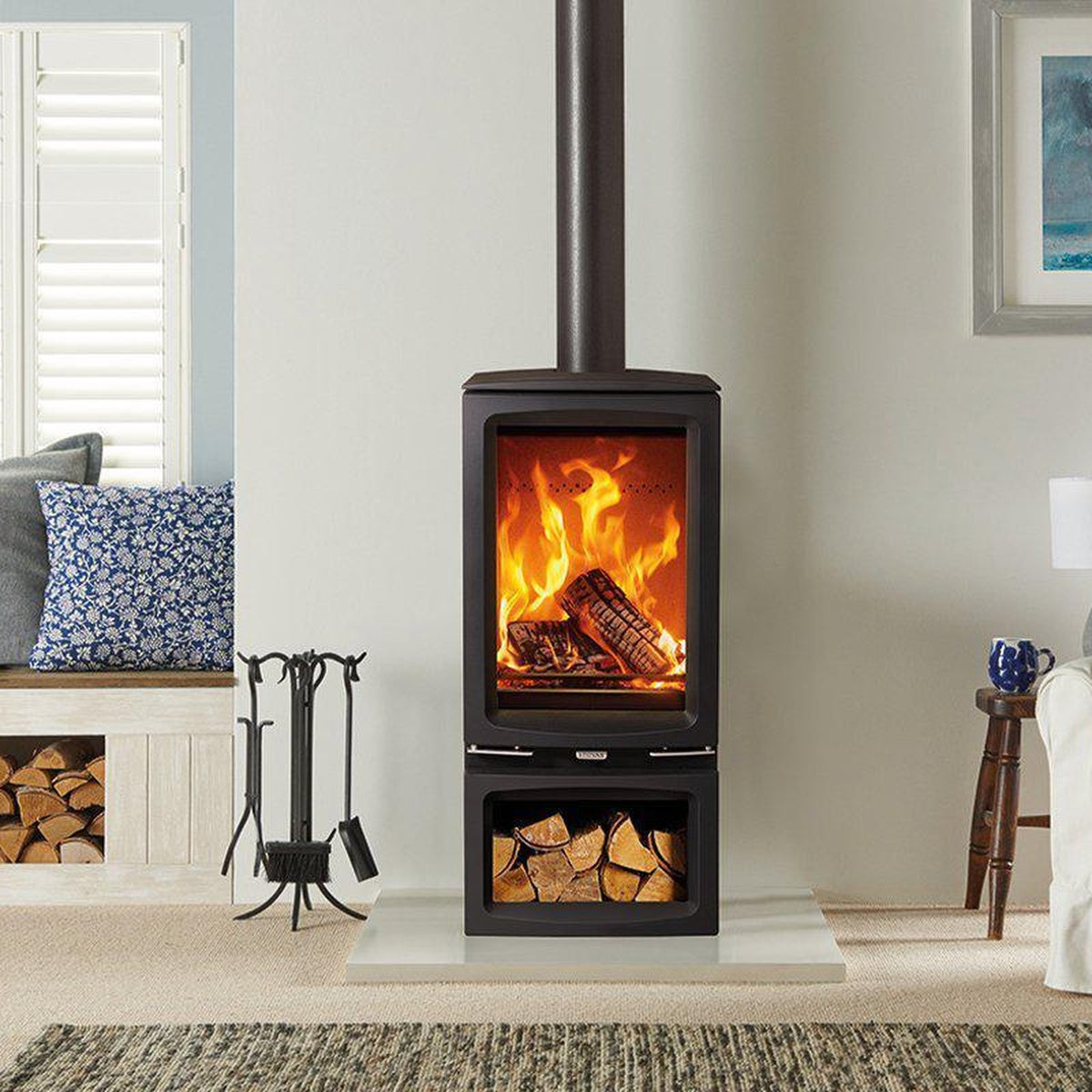 Stovax Vogue Midi T stove with Midline log-store base beside a window seat