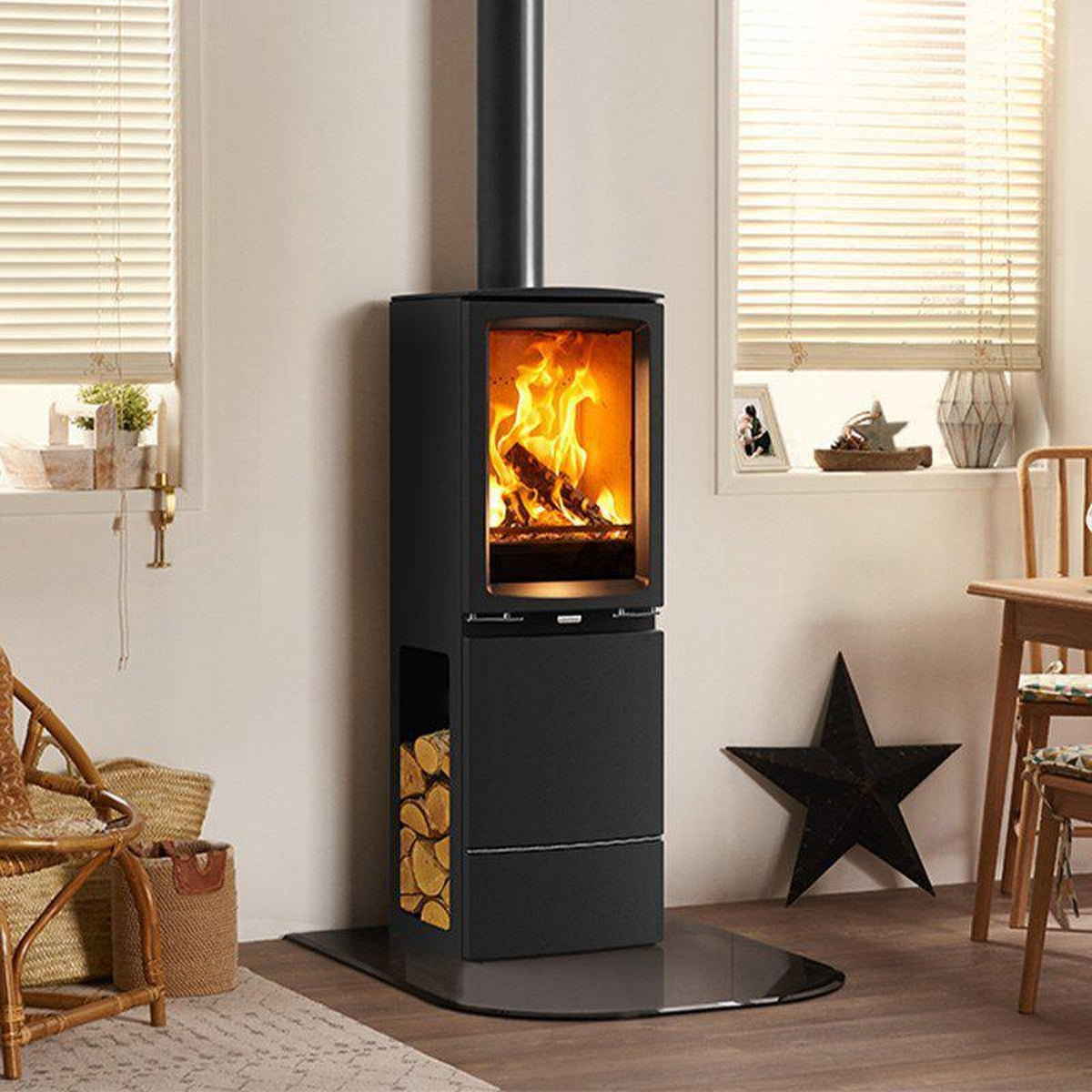 Stovax Vogue Midi T Highline stove on a hearth beside wicker furniture