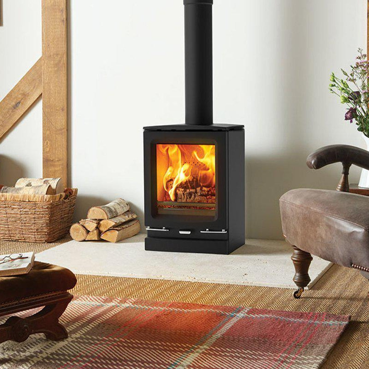 Stovax Vogue Small wood stove with plinth in a timber-framed room
