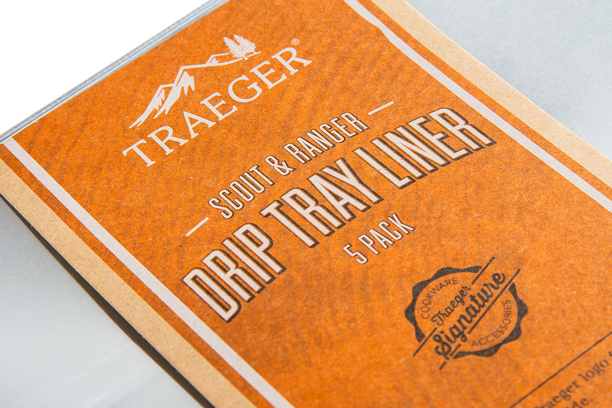 Close-up of the orange label on a five-pack of Traeger Scout and Ranger drip tray liners
