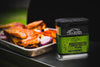 A closer view of the Traeger &quot;Pork &amp; Poultry Rub&quot; container, showcasing the green labeling and details such as &quot;100% natural ingredients,&quot; &quot;gluten-free,&quot; and &quot;GMO-free.&quot;