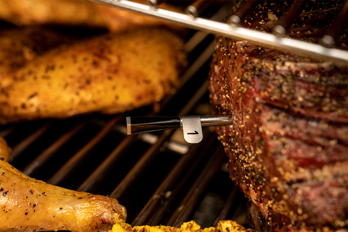 Close-up of Traeger x MEATER probe 1 inserted into a roast on the grill