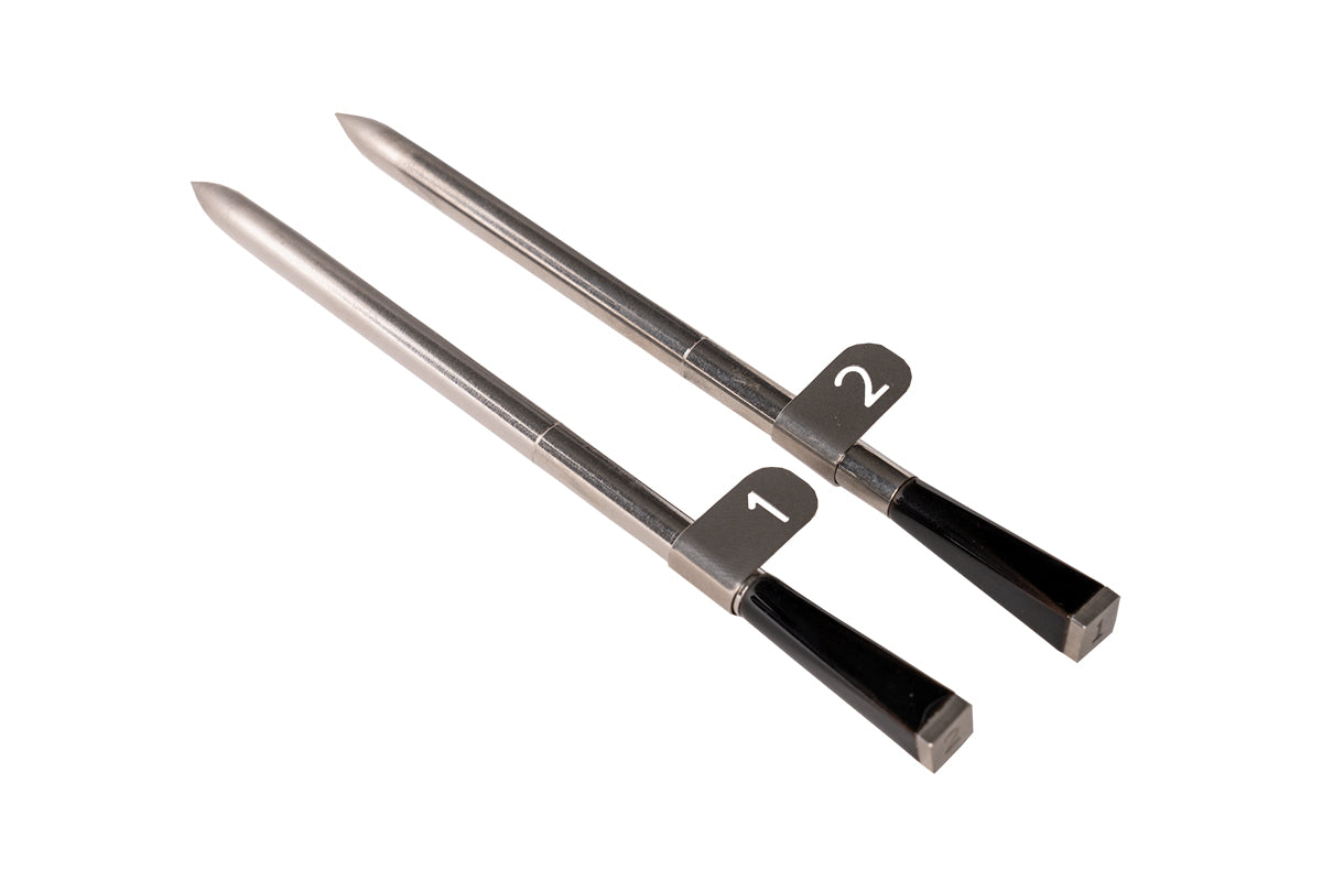 Pair of Traeger x MEATER wireless meat probes with numbered metal tabs and black ends